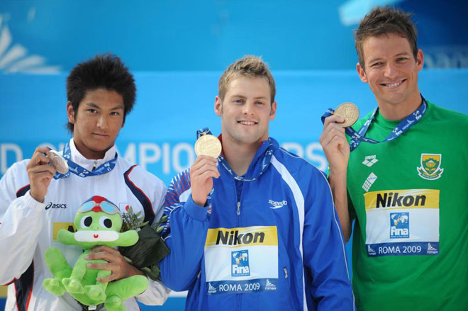 Con una sonrisa Liam Tancock (oro), Koga Junya (plata) y Gerhard Zandberg (bronce) ensean sus respectivas medallas conseguidas en la final de 50m espaldas.