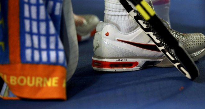 Rafael Nadal descansa en el partido de tercera ronda en la Rod Laver Arena de Melbourne. El balear luce en las zapatillas un motivo conmemorativo de su triunfo en 2009.