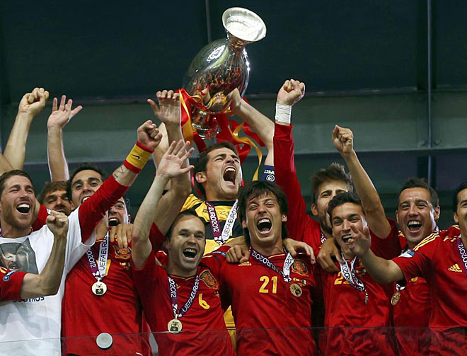 Spain's national soccer players celebrate with the trophy after defeating Italy to win the Euro 2012 final at the Olympic stadium in Kiev.