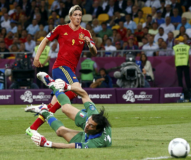 Spain's Juan Mata (2R) celebrates with Fernando Torres (C) and Pedro Rodriguez (7) after he scored the winning goal against Italy's Gianluigi Buffon (R) during their Euro 2012 final soccer match at the Olympic Stadium in Kiev.