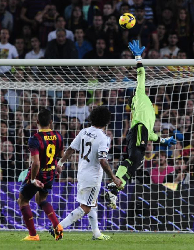 Alexis Sanchez scores during the Spanish league Clasico football match.
