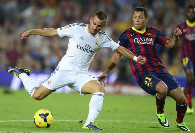 Jese Rodriguez vies Barcelona's Brazilian defender Adriano during the Spanish league Clasico football match.