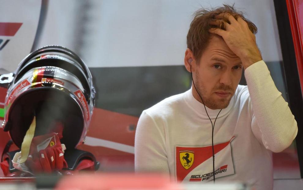 Ferrari's German driver Sebastian Vettel sits in his garage during the...