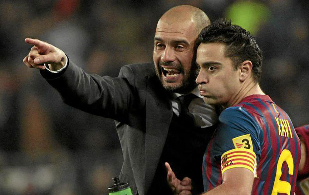 Xavi y Guardiola en un partido de Liga con el Bara.