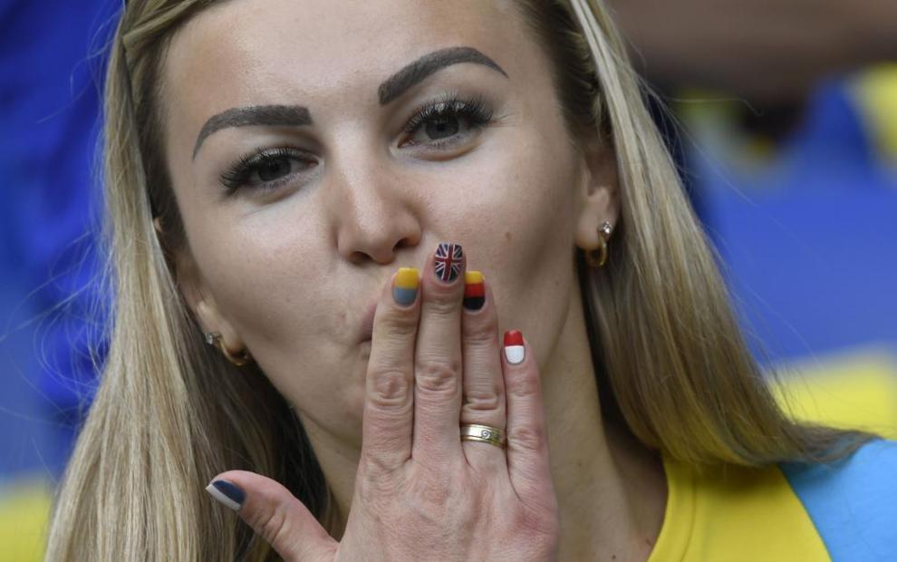 An Ukraine supporter blows a kiss before the Euro 2016 group C...