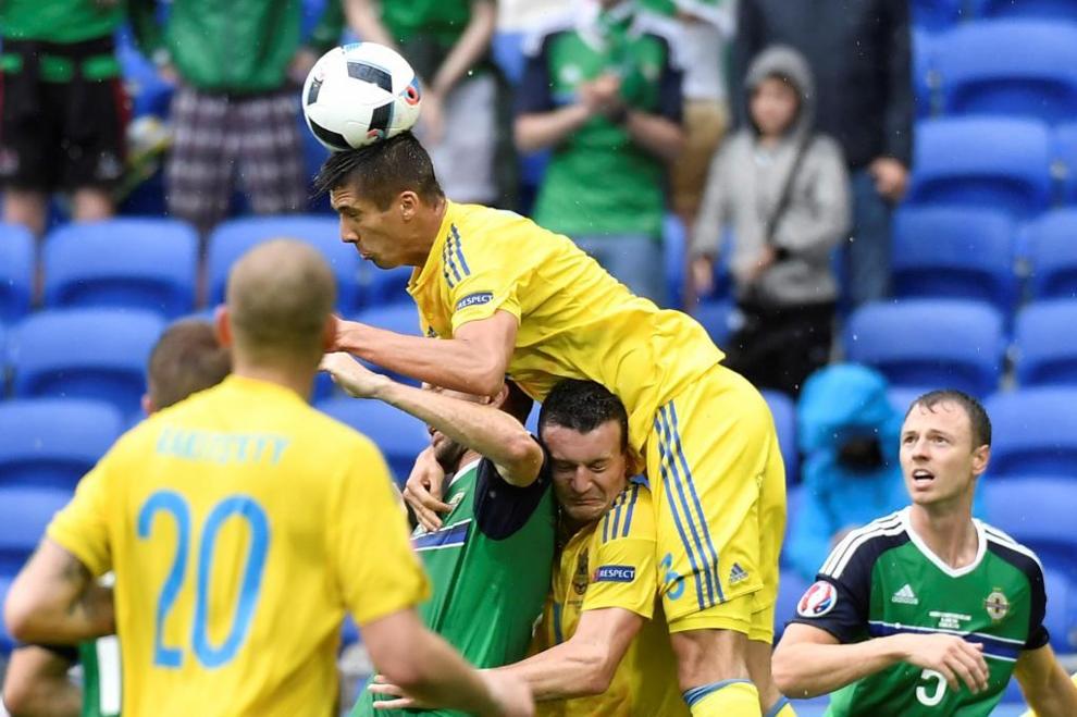 Ukraine's defender Yevhen Khacheridi (top) heads the ball during the...