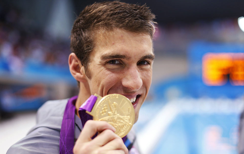 Phelps poses with his gold medal in the London Olympics