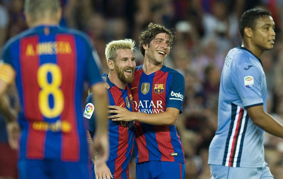 Messi celebrates with Sergi Roberto after scoring a goal.