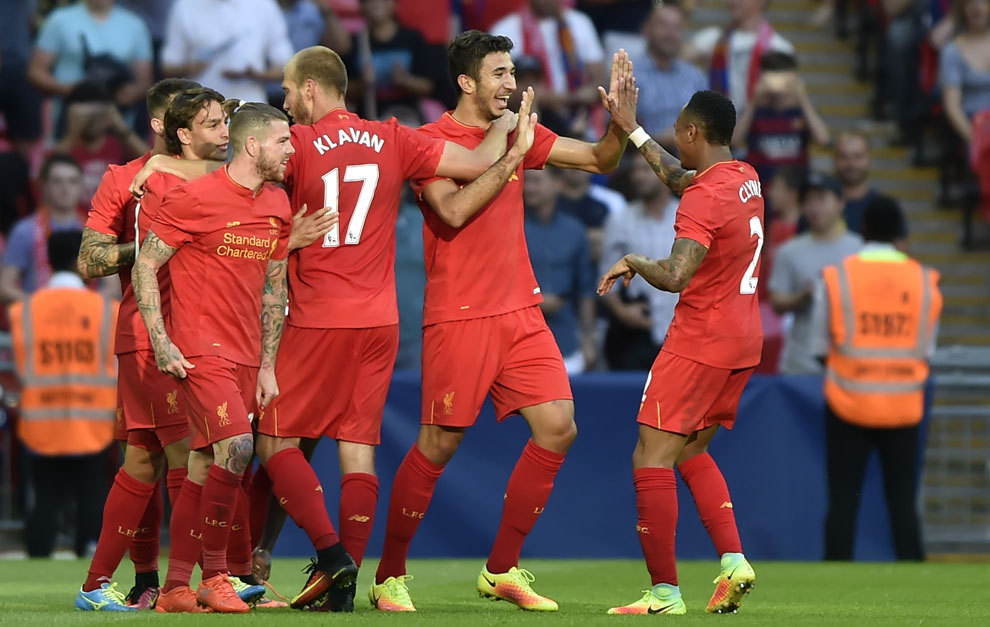Liverpool players celebrating a goal during a pre-season match.