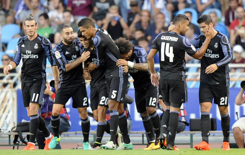 Real Madrid players celebrating after a goal against Real Sociedad.