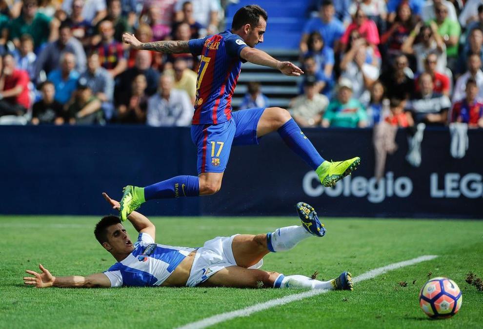 Barcelona's forward Paco Alcacer (up) jumps over Leganes' defender...