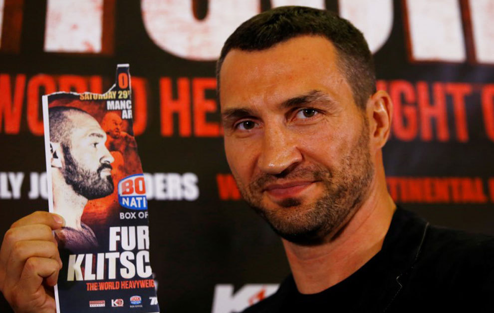 Wladimir Klitschko poses with an image of Tyson Fury during a press...