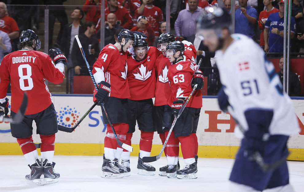 Team Canada celebrates after scoring a goal in the third period.