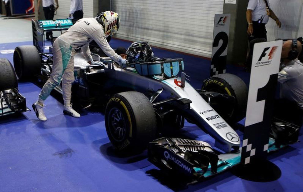 Lewis Hamilton congratulates Mercedes&apos; Nico Rosberg after the...