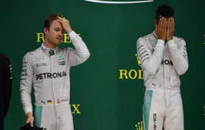 Rosberg se atusa el pelo y Hamilton se seca el sudor de la cara en el...