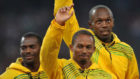 Nesta Carter, Michael Frater y Usain Bolt, en Pekn