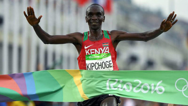 Eliud Kipchoge of Kenya crosses the finish line to win gold in the...