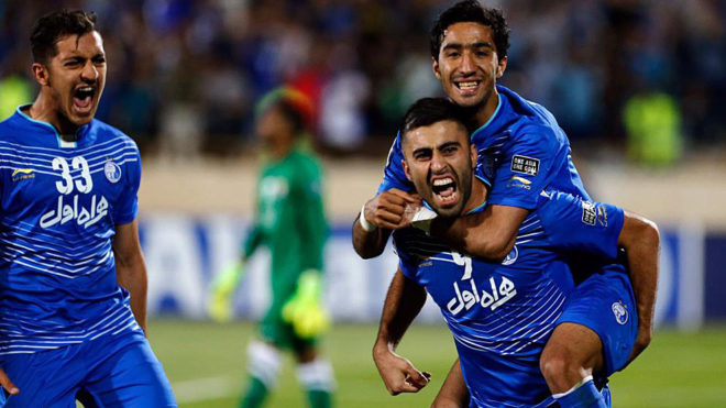 Esteghlal&apos;s Kaveh Rezaie celebrates with his teammates after scoring.
