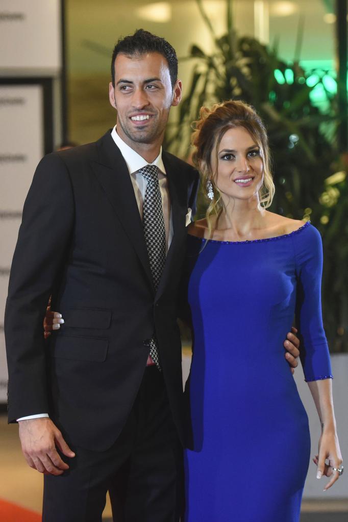Barcelonas football player Sergio Busquets and his wife pose on a red...