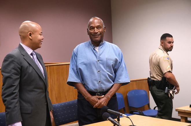 O.J. Simpson (center) arrives for his parole hearing at Lovelock...