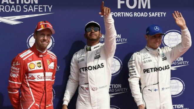 Hamilton celebra la 'pole' escoltado por Vettel y Bottas.