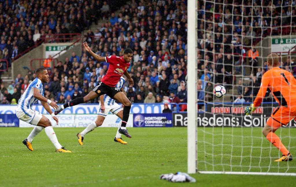 Manchester United&apos;s Marcus Rashford scores his side&apos;s first goal...