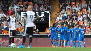 Los jugadores del Valencia ven como el Getafe celebra su gol.