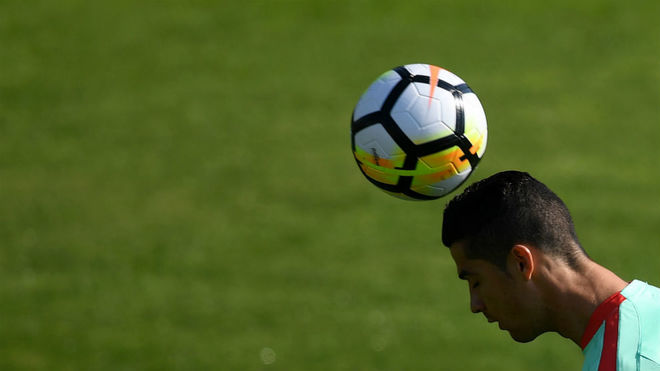 Cristiano Ronaldo heads the ball during a training session