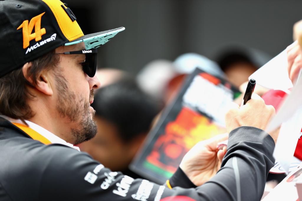 == FOR NEWSPAPERS, INTERNET, TELCOS & TELEVISION USE ONLY == MONTREAL, QC - JUNE 07: Fernando Alonso of Spain and McLaren F1 signs autographs for fans during previews ahead of the Canadian Formula One Grand Prix at Circuit Gilles Villeneuve on June 7, 2018 in Montreal, Canada. Mark Thompson/Getty Images/AFP