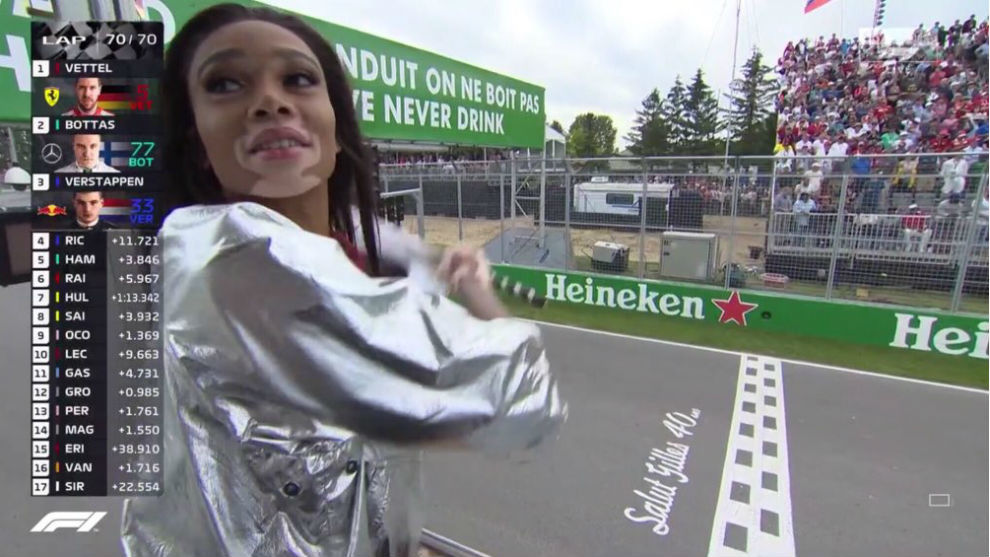 Winnie Harlow waves the chekered flag at the Canadian GP