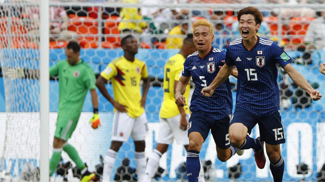 Yuya Osako celebrates with Japan&apos;s defender Yuto Nagatomo after...