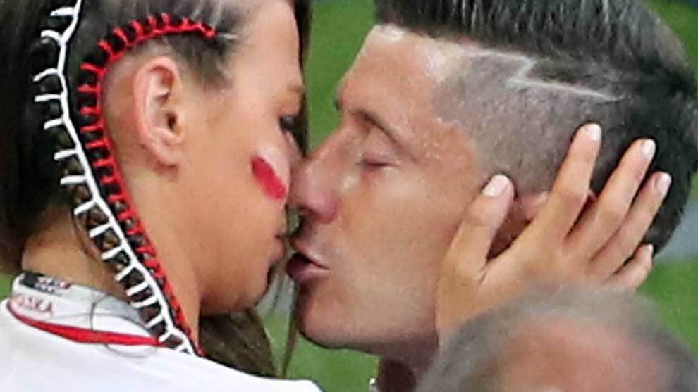 Robert Lewandowski (Poland) kisses his wife Anna after losing to...