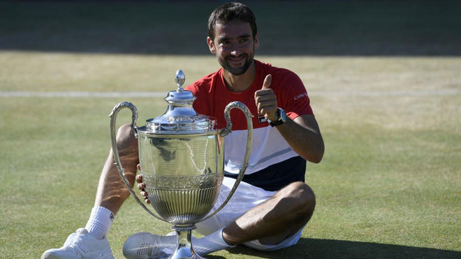 Marin Cilic poses with the trophy after winning against Novak Djokovic