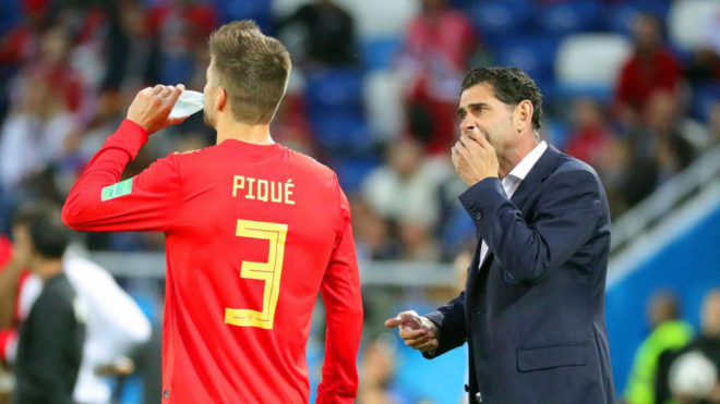 Fernando Hierro gives instructions to Gerard Pique during the match...