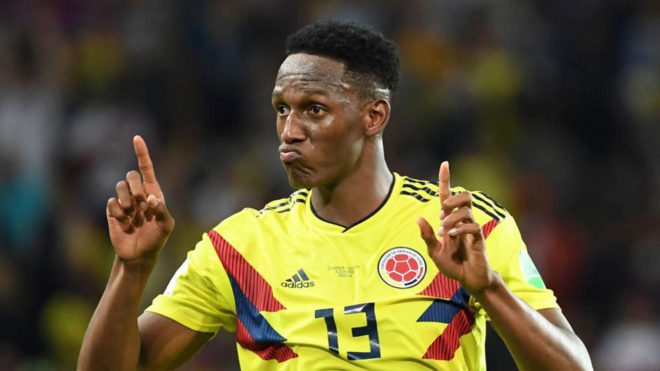 Yerry Mina celebrates after scoring the equalizer during the match...