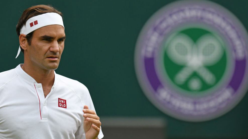 Federer, al lado del escudo de Wimbledon
