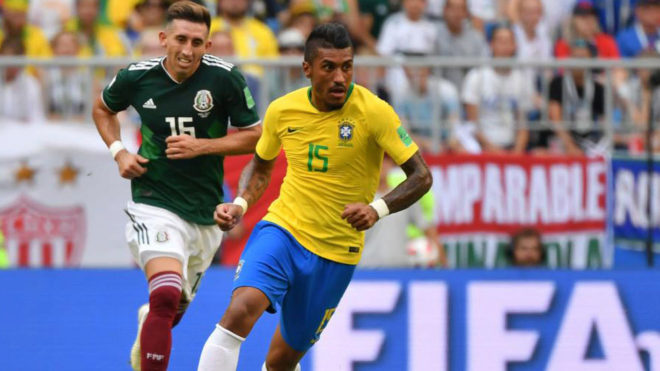 Paulinho vie for the ball during the match between Brazil and Mexico