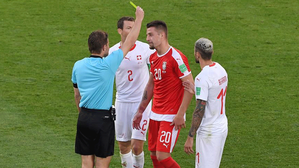 Milinkovic-Savic (2R) receives a yellow card from German referee Felix...