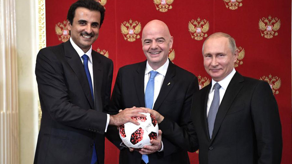 Al Thani, Putin and Infantino pose with a ball transferring World Cup...