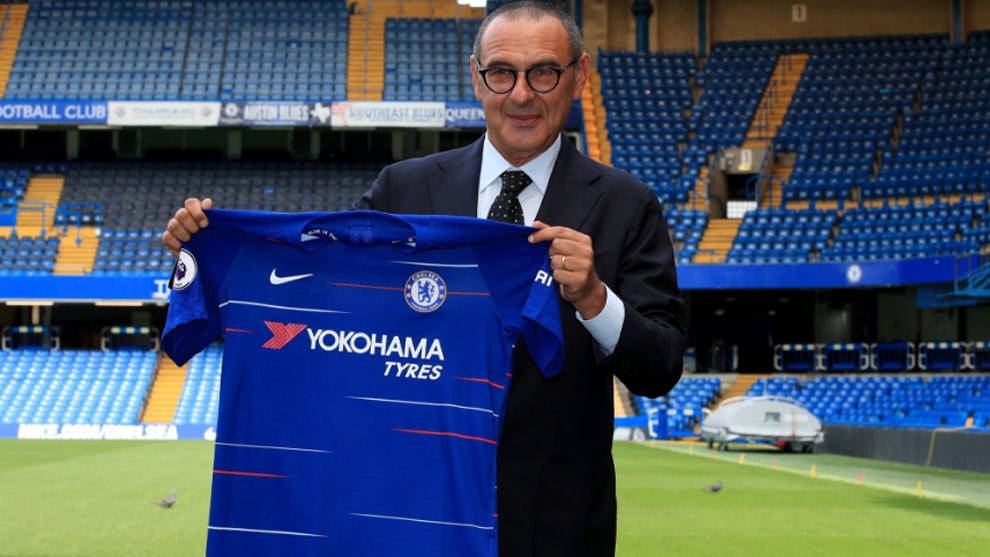 Chelsea&apos;s newly appointed manager, Maurizio Sarri, holds up a team...