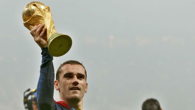 Antoine Griezmann of France celebrates with the World Cup trophy.