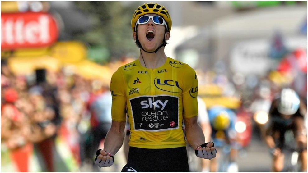 Geraint Thomas, wearing the overall leader&apos;s yellow jersey, celebrates...