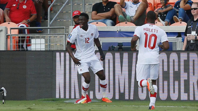 Alphonso Davies  celebrates with this teammates after scoring against...