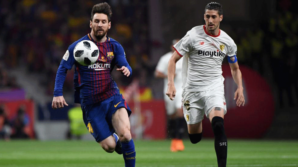Messi vies with Sevilla&apos;s defender Escudero during the Spanish Copa...