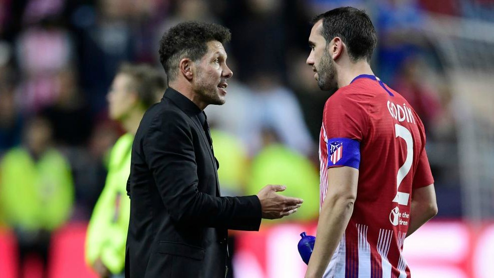 Simeone speaks to  Diego Godin at the end of the UEFA Super Cup match...
