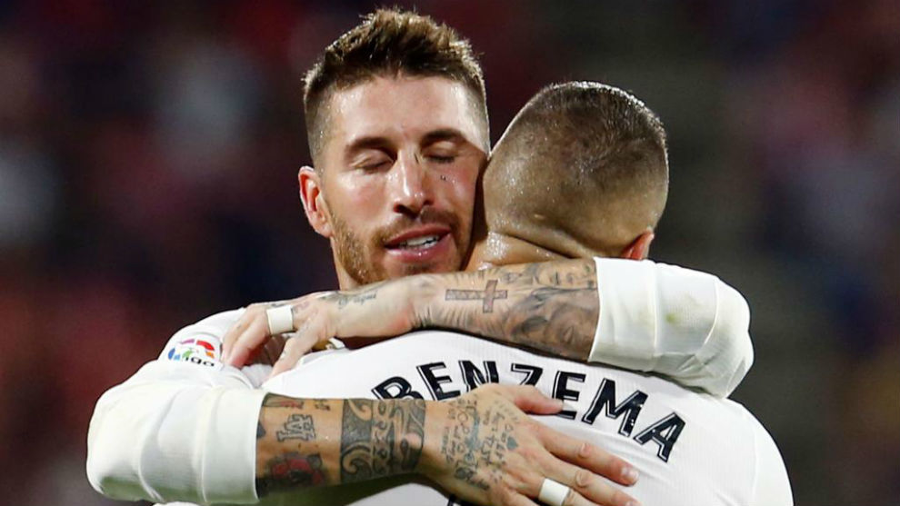 Sergio Ramos congratulates Real Madrid&apos;s French forward Karim Benzema...