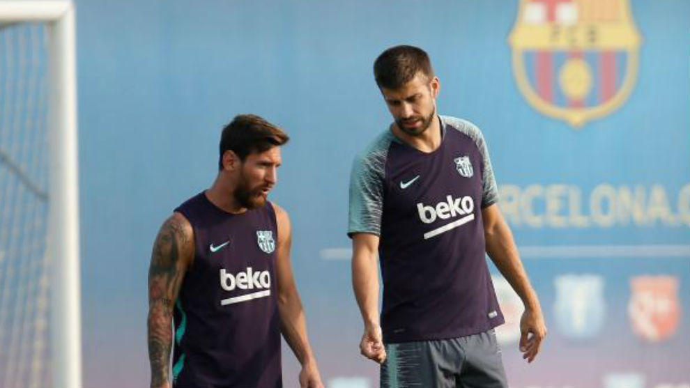 Messi listens to Pique during a training session at the FC Barcelona&apos;s...