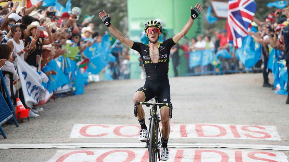Simon Yates celebrates as he wins the 14th stage