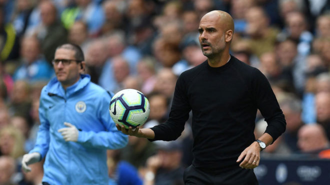 Pep Guardiola looks on during the Premier League match between...