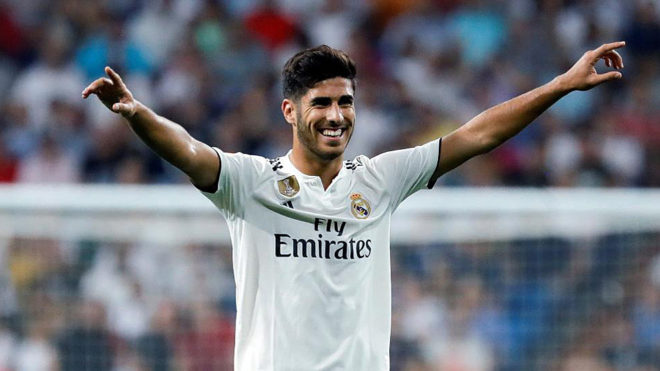 Real Madrid&apos;s Spanish midfielder Marco Asensio celebrates after...